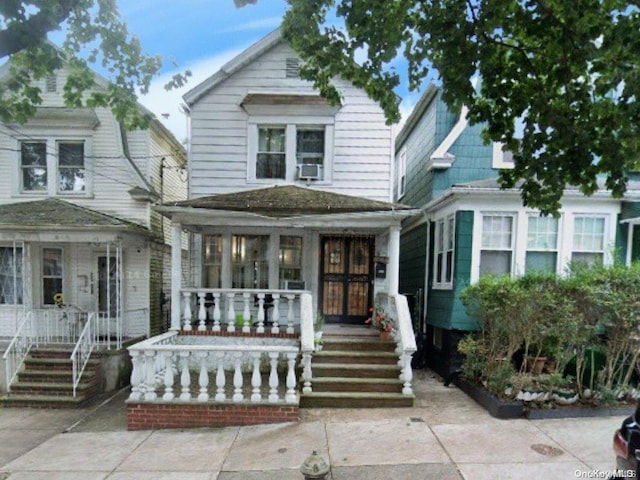 view of front of property with a porch and cooling unit