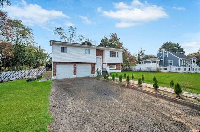 split foyer home with a garage and a front yard