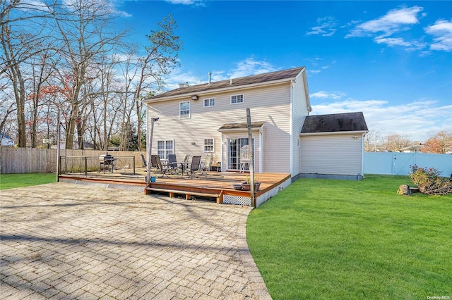 back of property featuring a yard and a deck