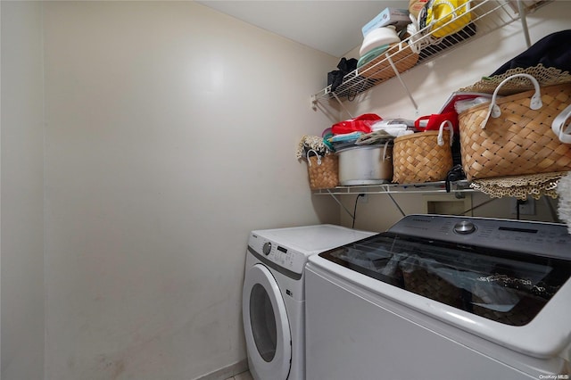 laundry room featuring washing machine and clothes dryer