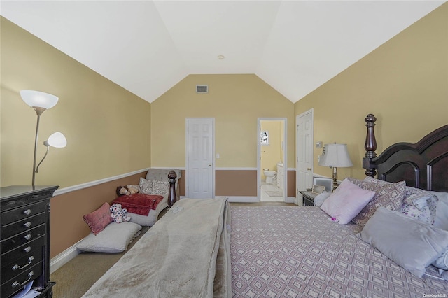 bedroom featuring carpet flooring, vaulted ceiling, and ensuite bath