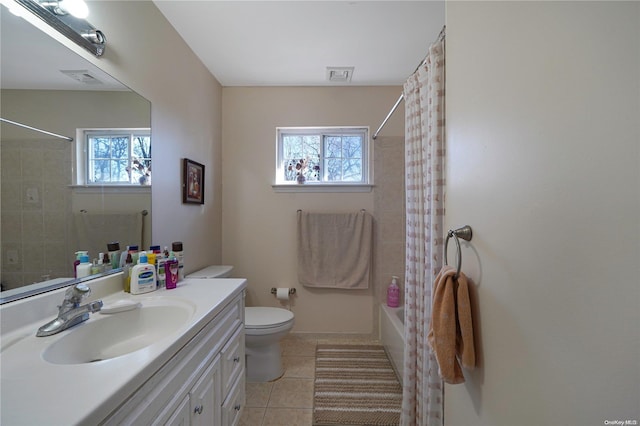 full bathroom featuring tile patterned floors, shower / bath combo with shower curtain, vanity, and a healthy amount of sunlight