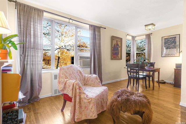 sitting room featuring light hardwood / wood-style floors, radiator, and cooling unit