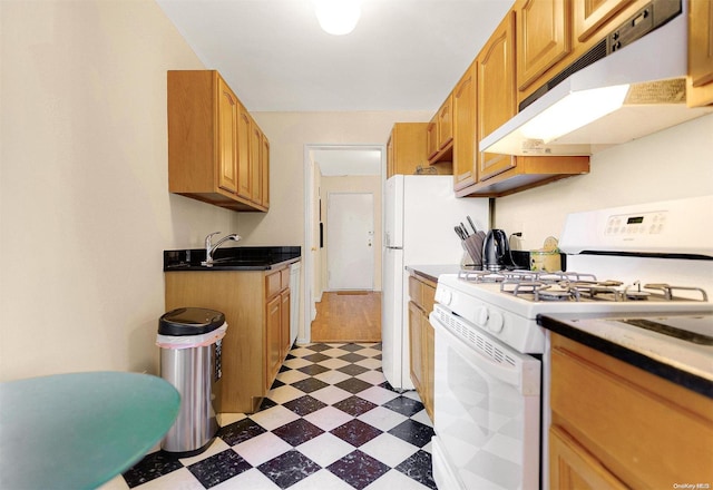 kitchen with white gas stove and sink