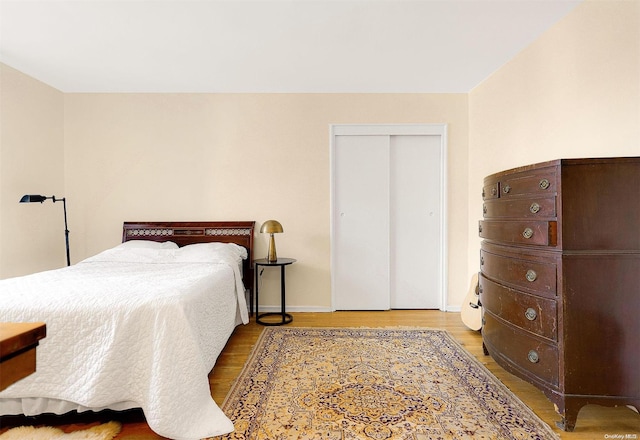 bedroom featuring hardwood / wood-style flooring and a closet