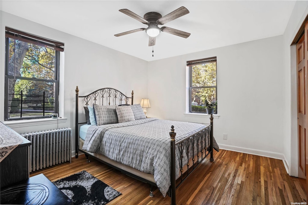 47-27 215th Pl Unit 1A, Bayside, NY 11361 - bedroom with a closet, dark hardwood / wood-style floors, radiator, and ceiling fan