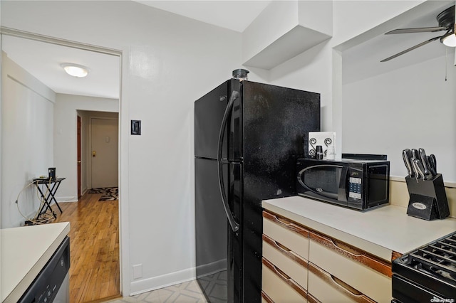 kitchen featuring ceiling fan, white cabinets, black appliances, and light hardwood / wood-style floors