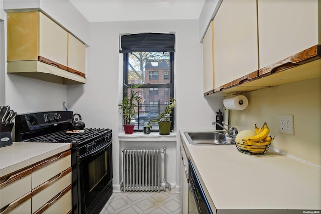 kitchen with radiator, sink, stainless steel dishwasher, white cabinetry, and black range with gas cooktop