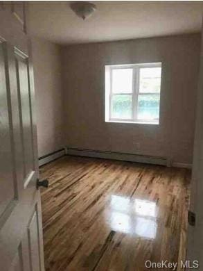 spare room featuring wood-type flooring