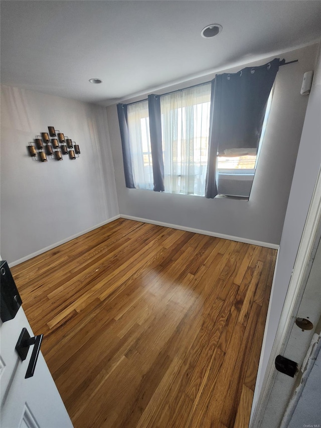 spare room with hardwood / wood-style flooring and a healthy amount of sunlight