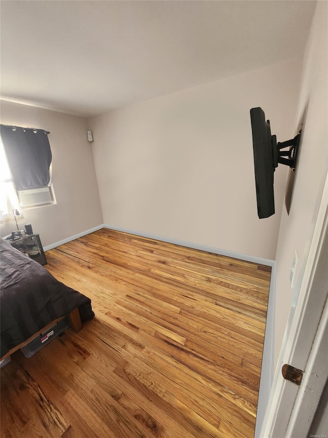 bedroom with hardwood / wood-style flooring