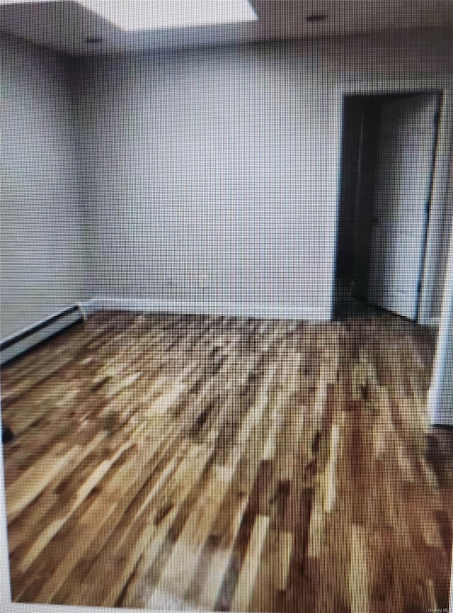 unfurnished room with dark wood-type flooring