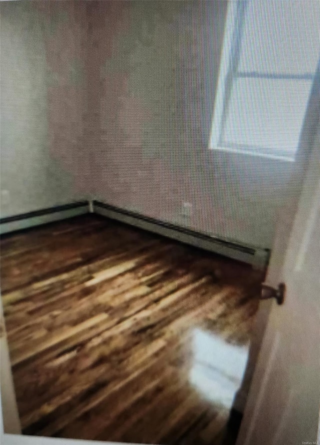 spare room featuring dark wood-type flooring