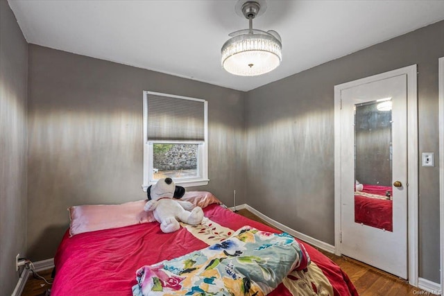 bedroom with dark hardwood / wood-style flooring