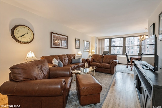 living room featuring light hardwood / wood-style floors and a notable chandelier