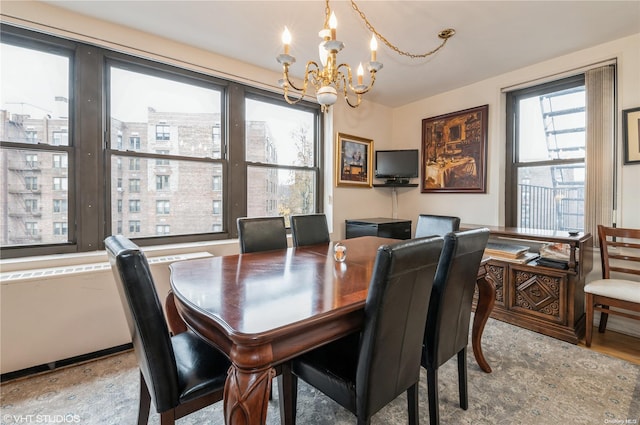 dining room featuring wood-type flooring and a notable chandelier