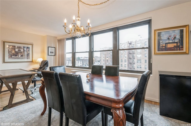 dining area featuring light hardwood / wood-style floors and a notable chandelier