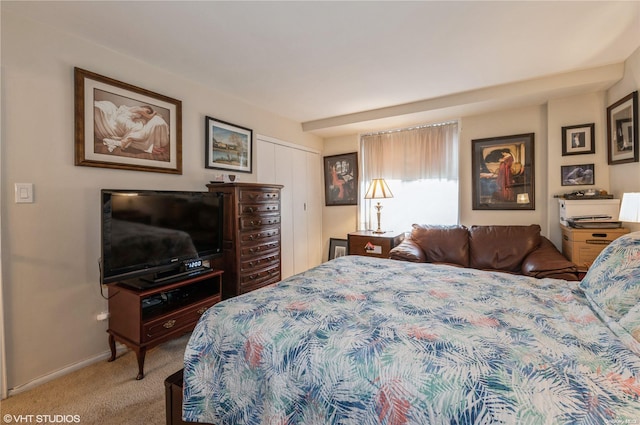 bedroom with carpet and a closet