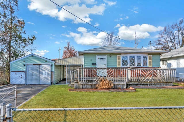 view of front of property with a front yard and an outbuilding