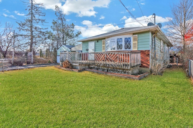 back of house with a yard and a wooden deck