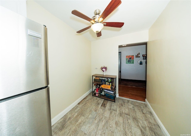 kitchen with stainless steel refrigerator, ceiling fan, and light hardwood / wood-style floors