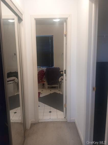 hall featuring light tile patterned flooring