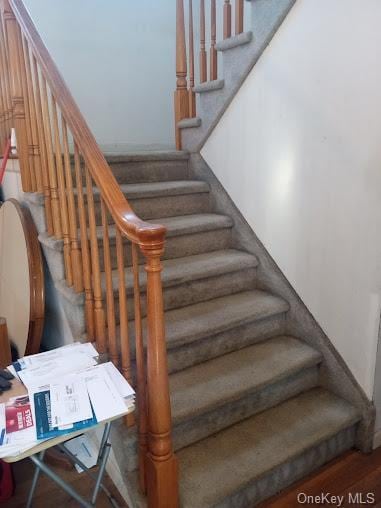 stairs with hardwood / wood-style flooring