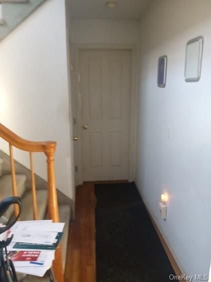 corridor featuring dark hardwood / wood-style floors