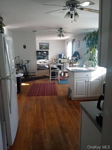 kitchen featuring ceiling fan, white cabinets, dark wood-type flooring, and white refrigerator