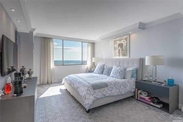 bedroom with carpet floors, a water view, and crown molding