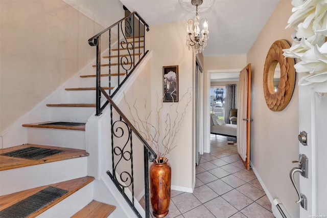 tiled foyer with an inviting chandelier and a baseboard heating unit