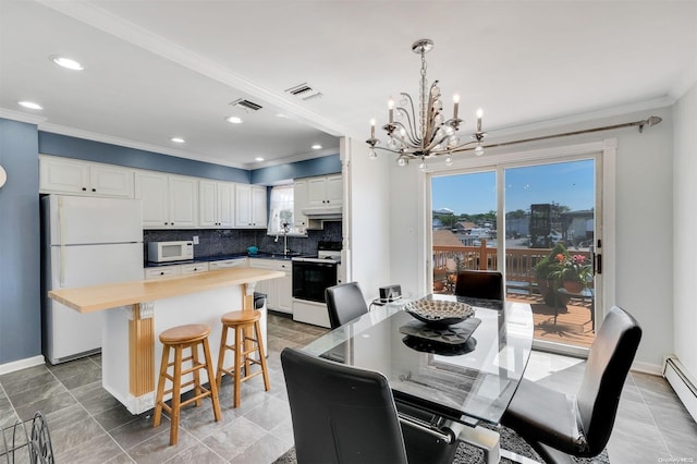 dining space featuring a baseboard radiator, crown molding, a notable chandelier, and sink