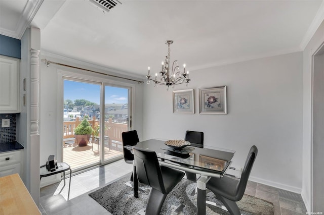 dining area with a chandelier and crown molding