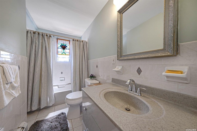 full bathroom with shower / bath combo, vanity, vaulted ceiling, tile walls, and tile patterned flooring