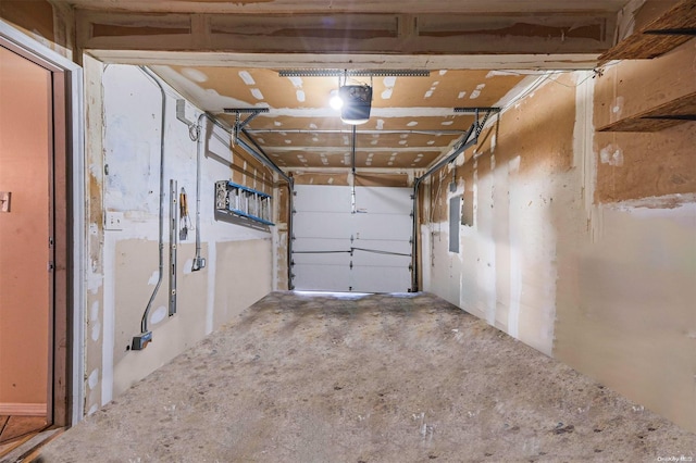 garage featuring electric panel and a garage door opener