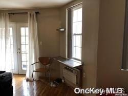 doorway featuring light hardwood / wood-style floors and a wall unit AC