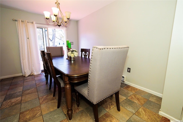 dining area with an inviting chandelier