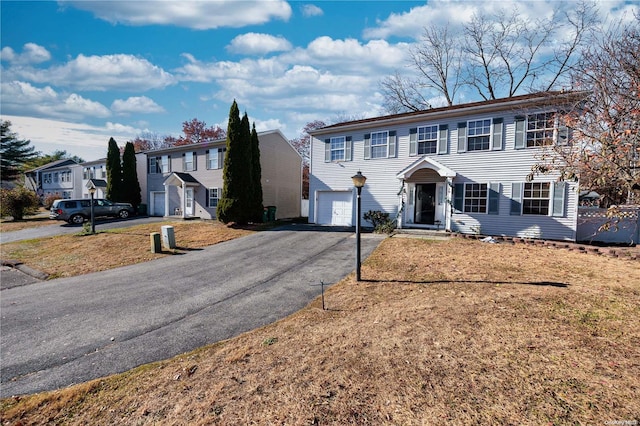 view of front of home with a front lawn and a garage