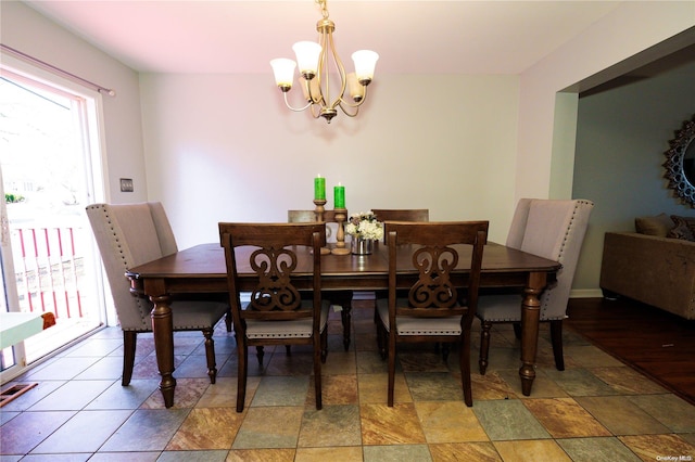 dining space featuring a notable chandelier and dark wood-type flooring