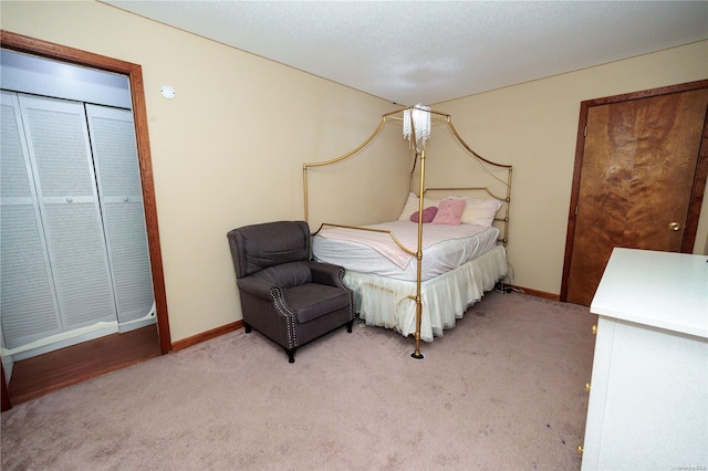 bedroom with a textured ceiling and light carpet