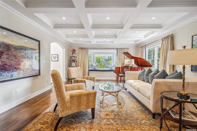 living room with beam ceiling, dark hardwood / wood-style flooring, a healthy amount of sunlight, and ornamental molding