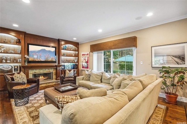 living room featuring a fireplace, dark hardwood / wood-style floors, and crown molding