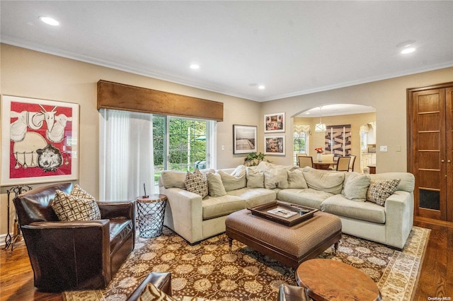 living room with wood-type flooring and ornamental molding