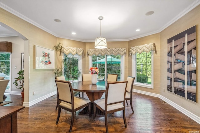 dining area featuring dark hardwood / wood-style floors and crown molding