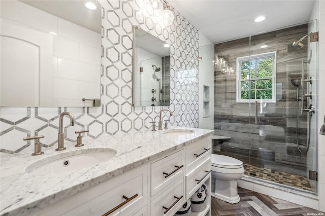 bathroom with vanity, parquet floors, toilet, tile walls, and a shower with shower door