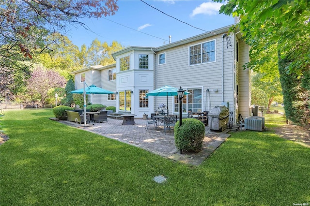 rear view of house with a yard, a patio area, and central air condition unit