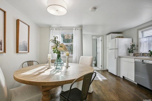 dining area with dark hardwood / wood-style flooring and sink