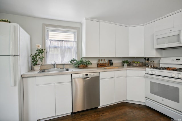 kitchen featuring dark hardwood / wood-style floors, white cabinetry, white appliances, and sink