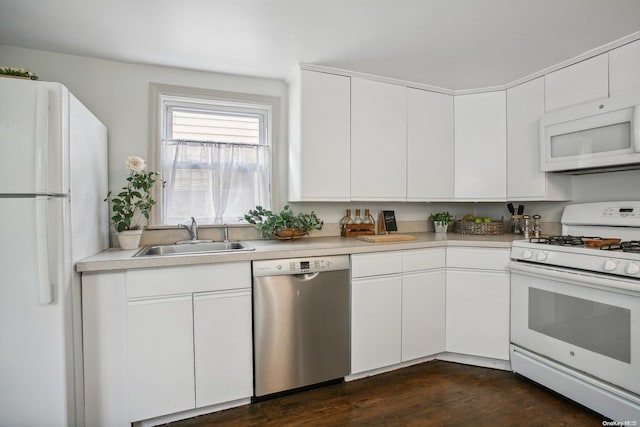 74 Davis St, Locust Valley, NY 11560 - kitchen featuring white appliances, a sink, white cabinetry, light countertops, and dark wood-style flooring