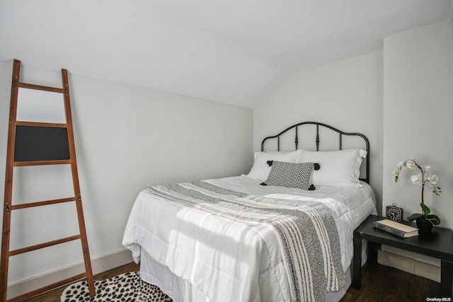 bedroom with lofted ceiling and dark wood-type flooring